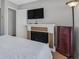 Bedroom with decorative fireplace and TV at 2699 Aldonza Dr, Henderson, NV 89014