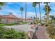 Well-maintained community with beautiful landscaping, mature palm trees, and walking paths at 2699 Aldonza Dr, Henderson, NV 89014