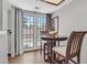 Bright dining area with wooden table, chairs, and views of the backyard and patio through glass doors at 2699 Aldonza Dr, Henderson, NV 89014