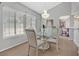 Bright dining space with hardwood floors, chandelier, and large window views at 2699 Aldonza Dr, Henderson, NV 89014