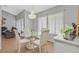 Open-concept dining room with chandelier, hardwood floors, and neutral paint at 2699 Aldonza Dr, Henderson, NV 89014