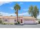 Charming single-story home with a desert landscape, tile roof, and attached two-car garage at 2699 Aldonza Dr, Henderson, NV 89014