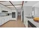 Well-lit kitchen with white cabinets, tile countertops, and modern appliances at 2699 Aldonza Dr, Henderson, NV 89014