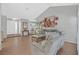 Open living room featuring vaulted ceilings, hardwood floors, and neutral tones at 2699 Aldonza Dr, Henderson, NV 89014