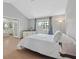 Spacious main bedroom with vaulted ceiling, walk in door, plush white bedding, and bright natural light at 2699 Aldonza Dr, Henderson, NV 89014