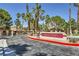Community sign, Laguna Verde, with lush landscaping and mature palm trees on a sunny day at 2708 Campo Verde Dr, Las Vegas, NV 89121