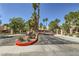 Community entrance with landscaping, palm trees, and an 'East Gate' sign at 2708 Campo Verde Dr, Las Vegas, NV 89121