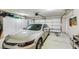 Spacious garage with car, white cabinetry, and white garage door provides ample storage at 2708 Campo Verde Dr, Las Vegas, NV 89121