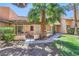 Cozy patio with seating area, surrounded by lush landscaping and a mature palm tree at 2708 Campo Verde Dr, Las Vegas, NV 89121