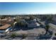 An aerial view of a home featuring solar panels, manicured landscaping, and a circular driveway at 2890 Belcastro St, Las Vegas, NV 89117