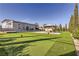 Expansive backyard featuring a putting green, covered gazebo, and manicured landscaping at 2890 Belcastro St, Las Vegas, NV 89117