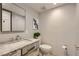 Elegant powder bathroom with a modern sink, textured white tile, and brushed metal finishes at 2890 Belcastro St, Las Vegas, NV 89117