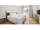 Bright primary bedroom with wood floors, a large window, and contemporary furniture at 2890 Belcastro St, Las Vegas, NV 89117