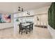 Bright dining room with modern star pendant lights, bold abstract artwork, and a view to living area at 2890 Belcastro St, Las Vegas, NV 89117