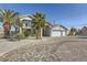 Stunning home features a three-car garage, balcony, mature landscaping, and paved driveway at 2890 Belcastro St, Las Vegas, NV 89117