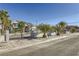 Well-maintained home with an ornate driveway gate and mature palm trees at 2890 Belcastro St, Las Vegas, NV 89117