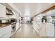 Modern white kitchen with stainless steel appliances, center island, and tile flooring at 2890 Belcastro St, Las Vegas, NV 89117