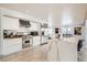Modern white kitchen with stainless steel appliances, center island, and open floor plan at 2890 Belcastro St, Las Vegas, NV 89117