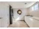 Clean and modern laundry room with stacked washer and dryer, long counter, and large mirror at 2890 Belcastro St, Las Vegas, NV 89117