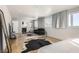 Bedroom with a sitting area, large windows providing natural light, and hardwood floors at 2890 Belcastro St, Las Vegas, NV 89117