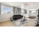 Bright bedroom featuring a seating area, large windows, hardwood floors, and contemporary design at 2890 Belcastro St, Las Vegas, NV 89117