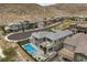 Stunning aerial view of a modern home with a private pool, spa, and rooftop deck with a spiral staircase at 2890 Reverence Heights Ln, Las Vegas, NV 89138