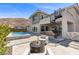 Modern backyard with pool, spa, spiral staircase and outdoor fire pit at 2890 Reverence Heights Ln, Las Vegas, NV 89138