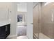 Bathroom featuring a glass-enclosed shower and neutral tile, with a glimpse into the adjoining bedroom at 2890 Reverence Heights Ln, Las Vegas, NV 89138
