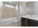 Clean, tiled bathroom featuring a shower-tub combination and a sleek vanity at 2890 Reverence Heights Ln, Las Vegas, NV 89138