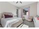 Well-lit bedroom featuring decorative headboard, accent chairs, and soft carpet flooring at 2890 Reverence Heights Ln, Las Vegas, NV 89138