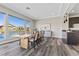 Bright dining room featuring a wooden table and gray vinyl floors at 2890 Reverence Heights Ln, Las Vegas, NV 89138