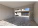 Covered driveway with gray pavers leading to a modern garage door and courtyard seating area at 2890 Reverence Heights Ln, Las Vegas, NV 89138