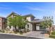 Two-story home with a modern exterior, landscaped front yard, and attached garage at 2890 Reverence Heights Ln, Las Vegas, NV 89138