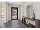 Inviting foyer features wood floors, console table, and a stylish mirror, creating a welcoming entrance at 2890 Reverence Heights Ln, Las Vegas, NV 89138