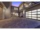Modern home featuring an attached garage with frosted glass paneling and a spacious paver driveway at 2890 Reverence Heights Ln, Las Vegas, NV 89138
