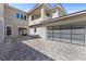 Modern home featuring an attached garage with frosted glass paneling and a spacious paver driveway at 2890 Reverence Heights Ln, Las Vegas, NV 89138