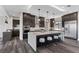 Modern kitchen features dark wood cabinetry, a large island, and stainless steel appliances at 2890 Reverence Heights Ln, Las Vegas, NV 89138