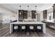 Modern kitchen features dark wood cabinetry, a large island, and stainless steel appliances at 2890 Reverence Heights Ln, Las Vegas, NV 89138