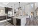 Open concept kitchen with large island, stainless steel appliances, and view of the living room at 2890 Reverence Heights Ln, Las Vegas, NV 89138