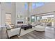 Bright living room featuring a floor to ceiling fireplace, hardwood floors, and comfortable seating at 2890 Reverence Heights Ln, Las Vegas, NV 89138