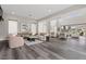 Bright, open-concept living room features soaring ceilings, wood floors, and seamless flow to outdoor spaces at 2890 Reverence Heights Ln, Las Vegas, NV 89138