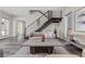 Living room showcasing sleek wood floors, modern staircase, and comfortable seating arrangement with art accents at 2890 Reverence Heights Ln, Las Vegas, NV 89138