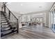 Open-concept living room with hardwood floors, staircase, and lots of sunlight, perfect for relaxing at 2890 Reverence Heights Ln, Las Vegas, NV 89138