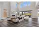 Bright living room featuring a floor to ceiling fireplace, hardwood floors, and comfortable seating at 2890 Reverence Heights Ln, Las Vegas, NV 89138