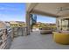 Stylish outdoor kitchen area with stainless steel grill, refrigerator, and comfortable seating on a covered patio at 2890 Reverence Heights Ln, Las Vegas, NV 89138