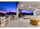 Outdoor kitchen features a built-in grill and stone accents on a covered patio with comfortable seating at 2890 Reverence Heights Ln, Las Vegas, NV 89138