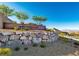 Community entrance featuring a 'Reverence' sign, stone landscaping, and mountain views at 2890 Reverence Heights Ln, Las Vegas, NV 89138