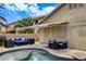 Backyard patio with pool and comfortable lounge furniture, ideal for outdoor relaxation at 2958 Lapis Beach Dr, Las Vegas, NV 89117