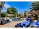 Inviting backyard pool area with a tiki bar and comfortable seating, perfect for outdoor entertaining at 2958 Lapis Beach Dr, Las Vegas, NV 89117