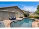 Private pool with stone accents and cozy outdoor seating enhances this backyard oasis at 2958 Lapis Beach Dr, Las Vegas, NV 89117